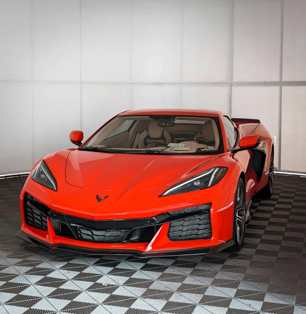 a red sports car sitting in a garage