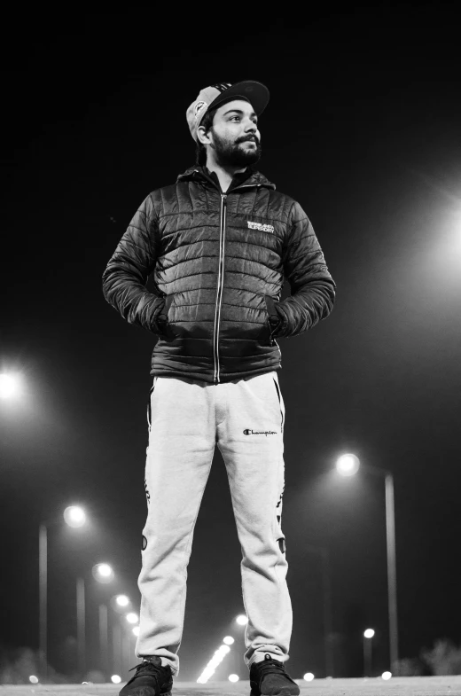 a man standing in front of street lights