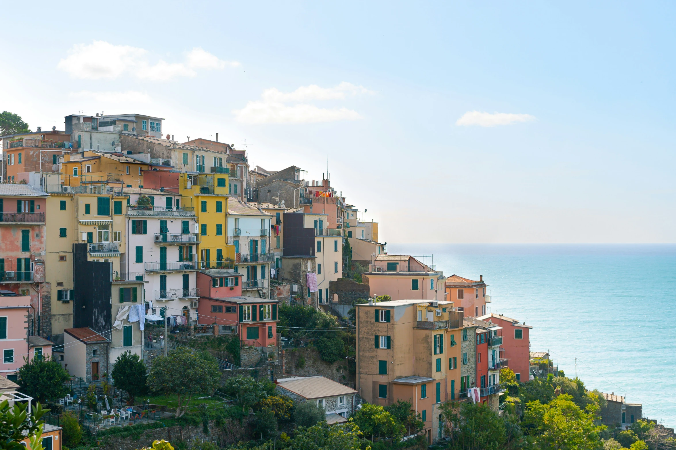 a po of many multi - colored buildings line the shoreline