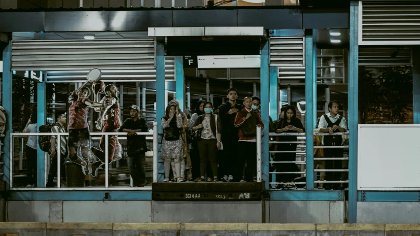 people stand at the top of the steps of a building