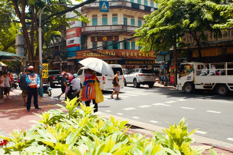 a group of people walking around in front of shops