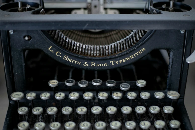 an antique black typewriter with it's own manual