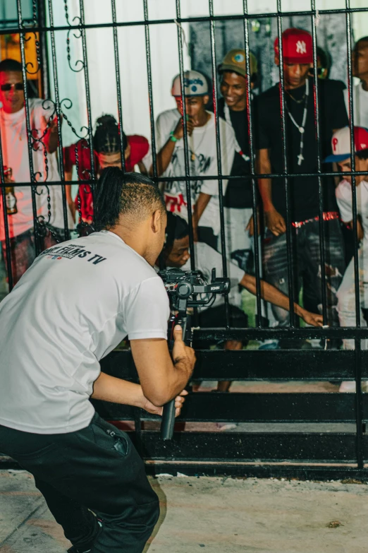 a person standing near a fence looking in a cage