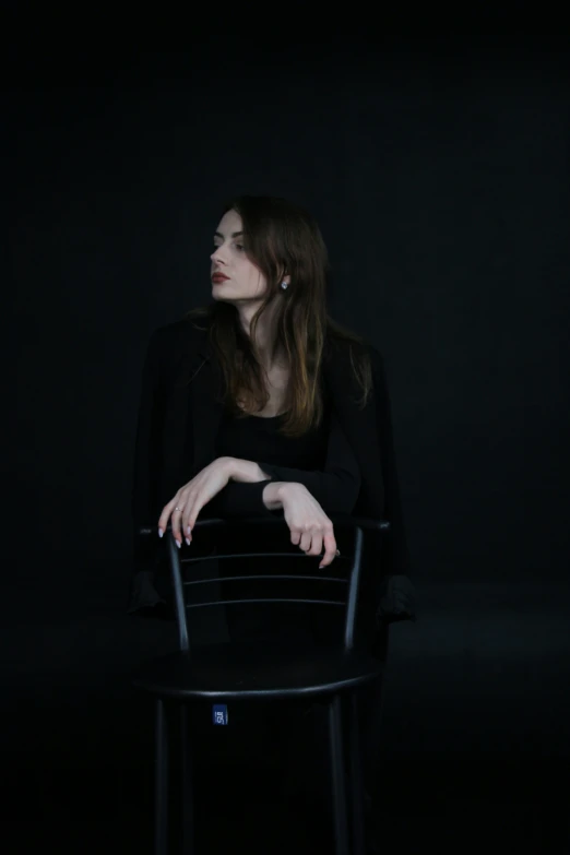 woman sitting on a chair and posing for camera