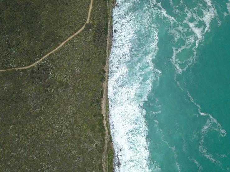 a beach with a wave in the ocean