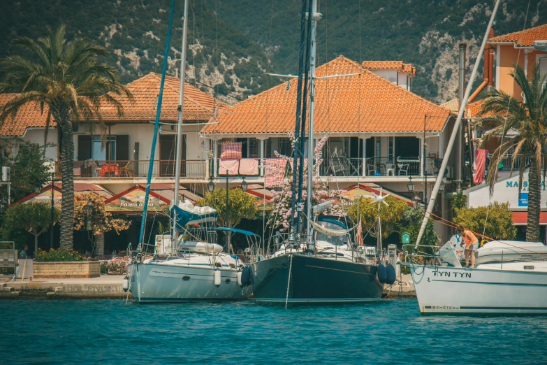 three boats on the water in front of a el