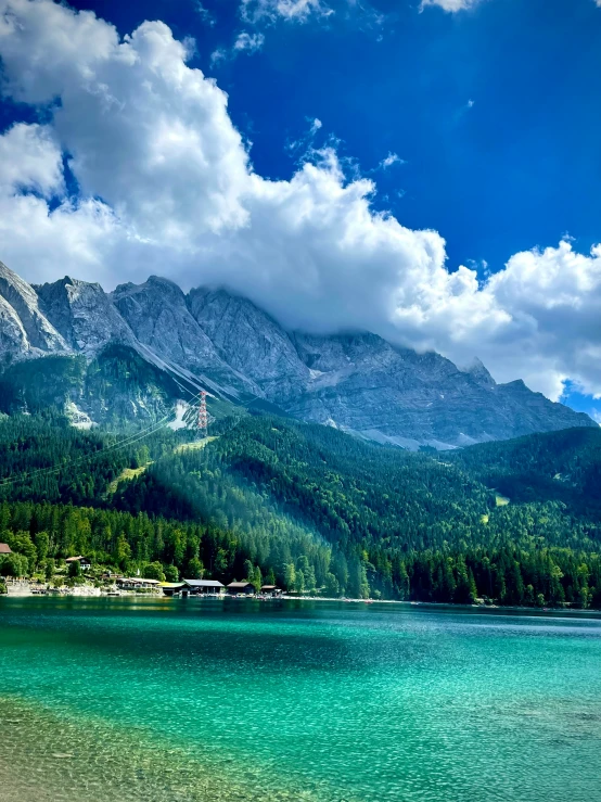 mountains surround a body of water with a beach on one side