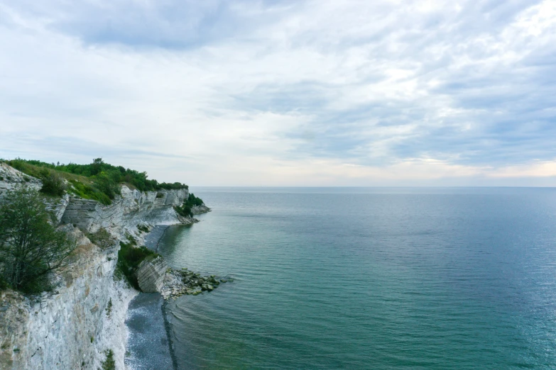 the cliffs are along the shoreline with the water