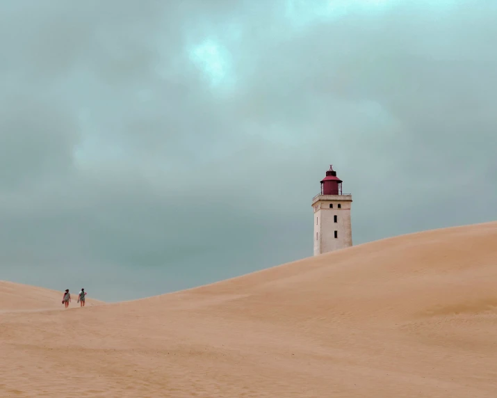 a tower sits above the sand dunes
