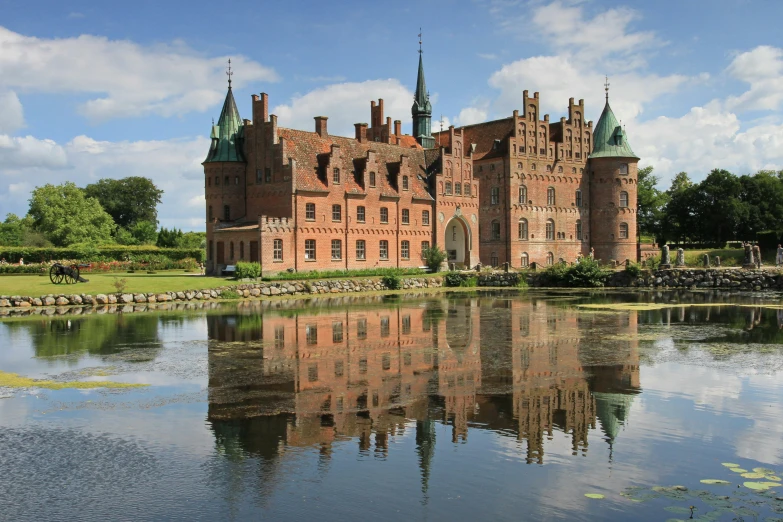 the building is reflected in the still water