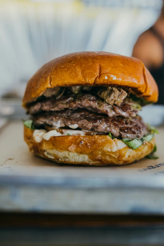 a big tasty looking hamburger on the tray