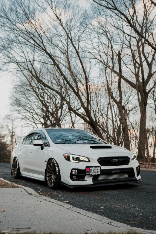 a white subaruce parked on the side of a road