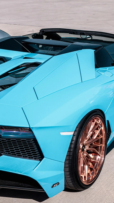 a bright blue sports car is parked in the parking lot