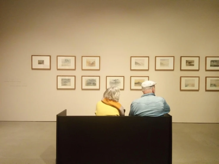 people sitting in front of a display at a museum