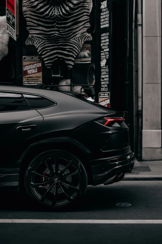 a very sleek black car parked on the street