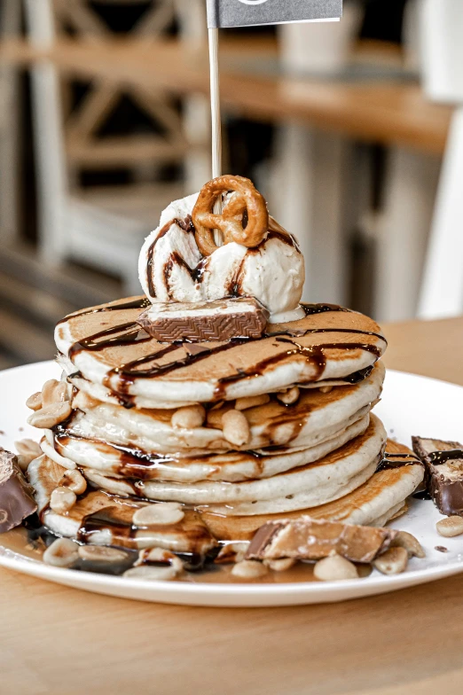 a stack of pancakes sitting on top of a table covered in chocolate