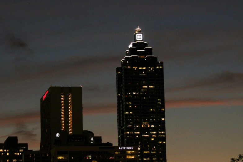 a tall building with a clock tower and sky line in the background