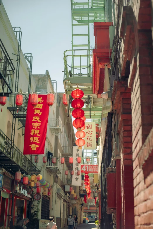 the woman is standing in the narrow alley with her bags