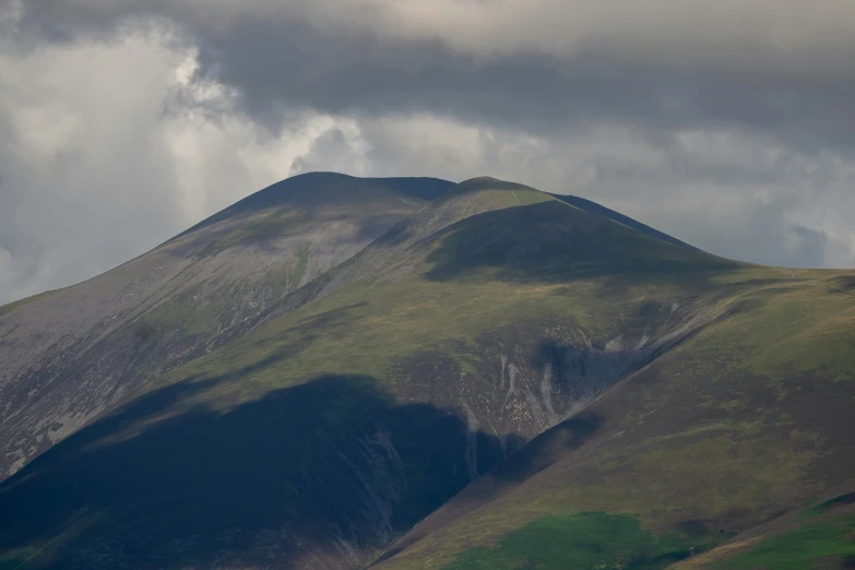 a lone plane is flying across the horizon of an image of some hills and mountains