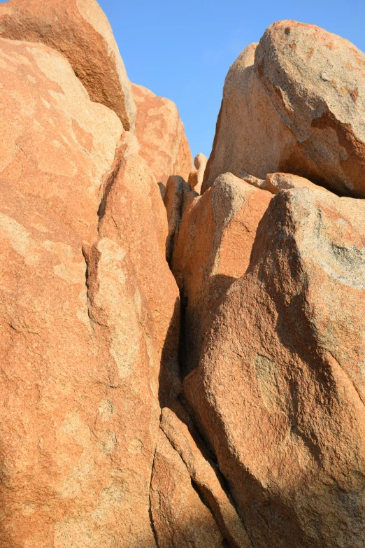 a person climbing up to a rock formation