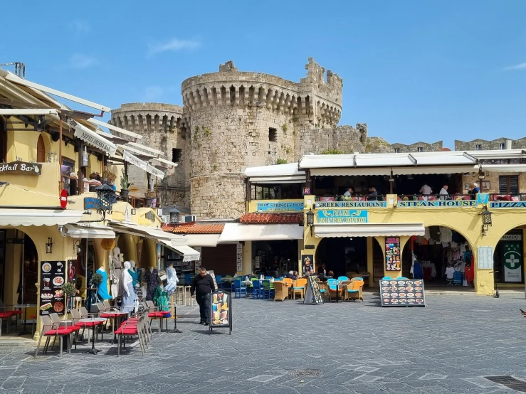 old town square with people standing in front of the castle