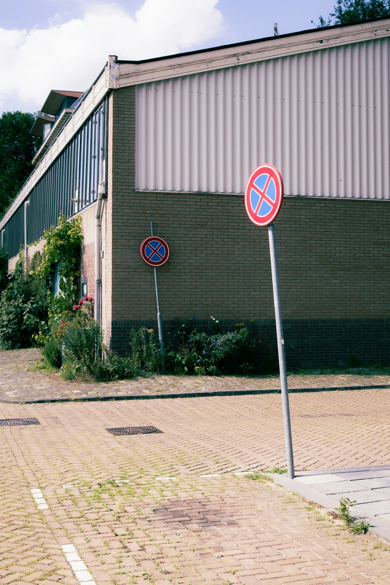 stop and no parking signs are pictured against a brick wall