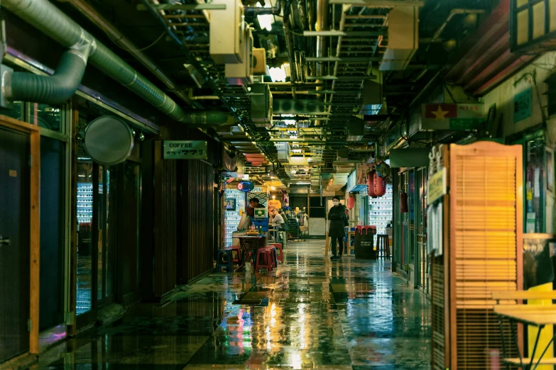 an alley with many stores in it and a few people on the side walk