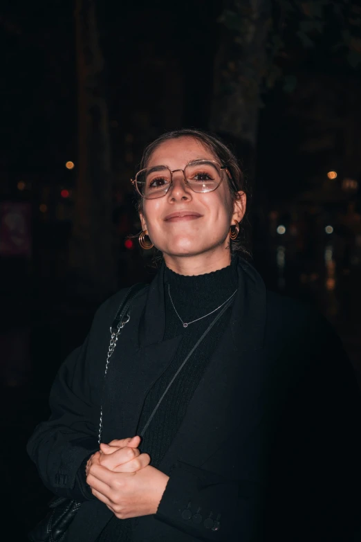 a woman posing for a picture in the dark