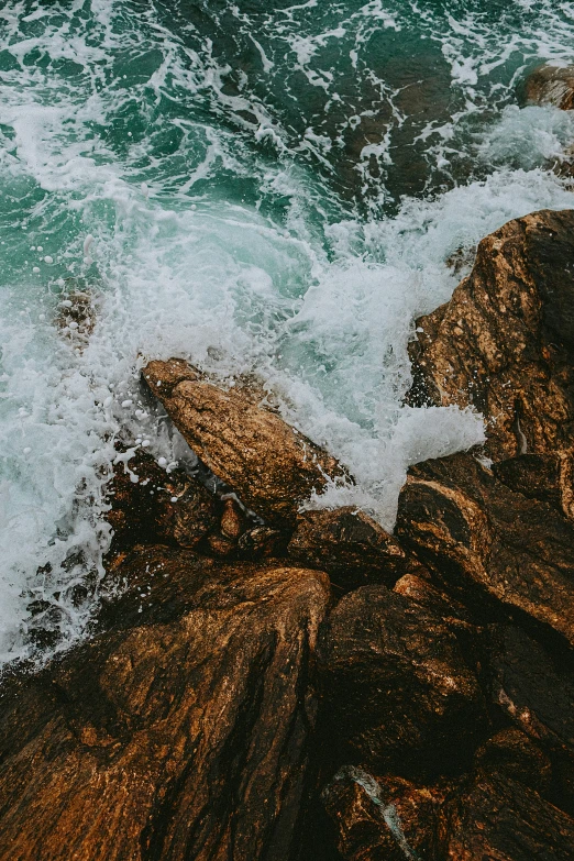 a cliff with the ocean crashing onto it