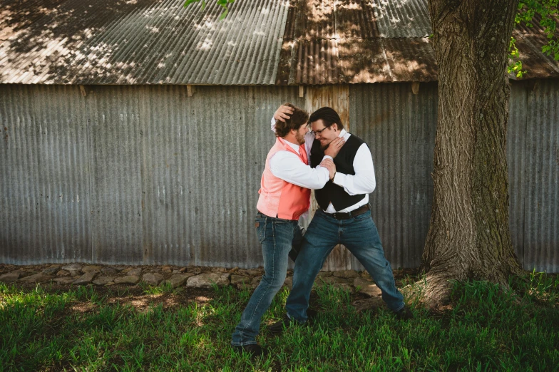 a young man and woman are dancing in the grass