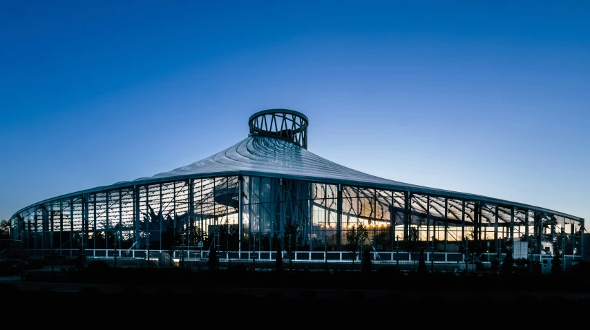 the large building has many windows and a clock on it