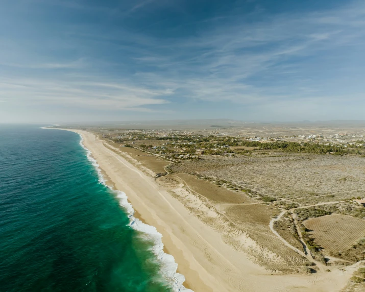 an ocean view shows a sandy shore and a sandy beach