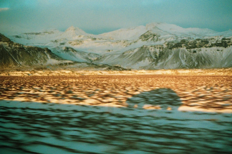 the view from an airplane shows mountains and a forest