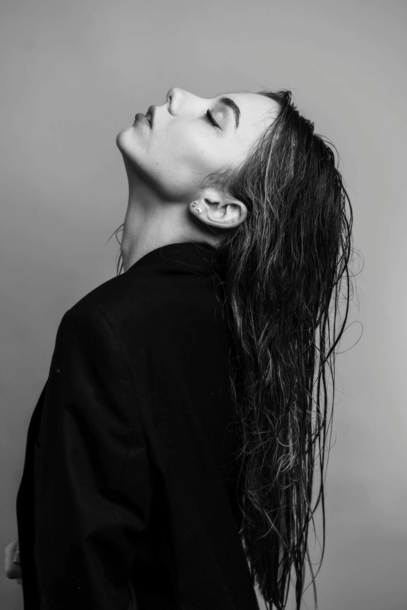 a woman with wet hair posing with her ear