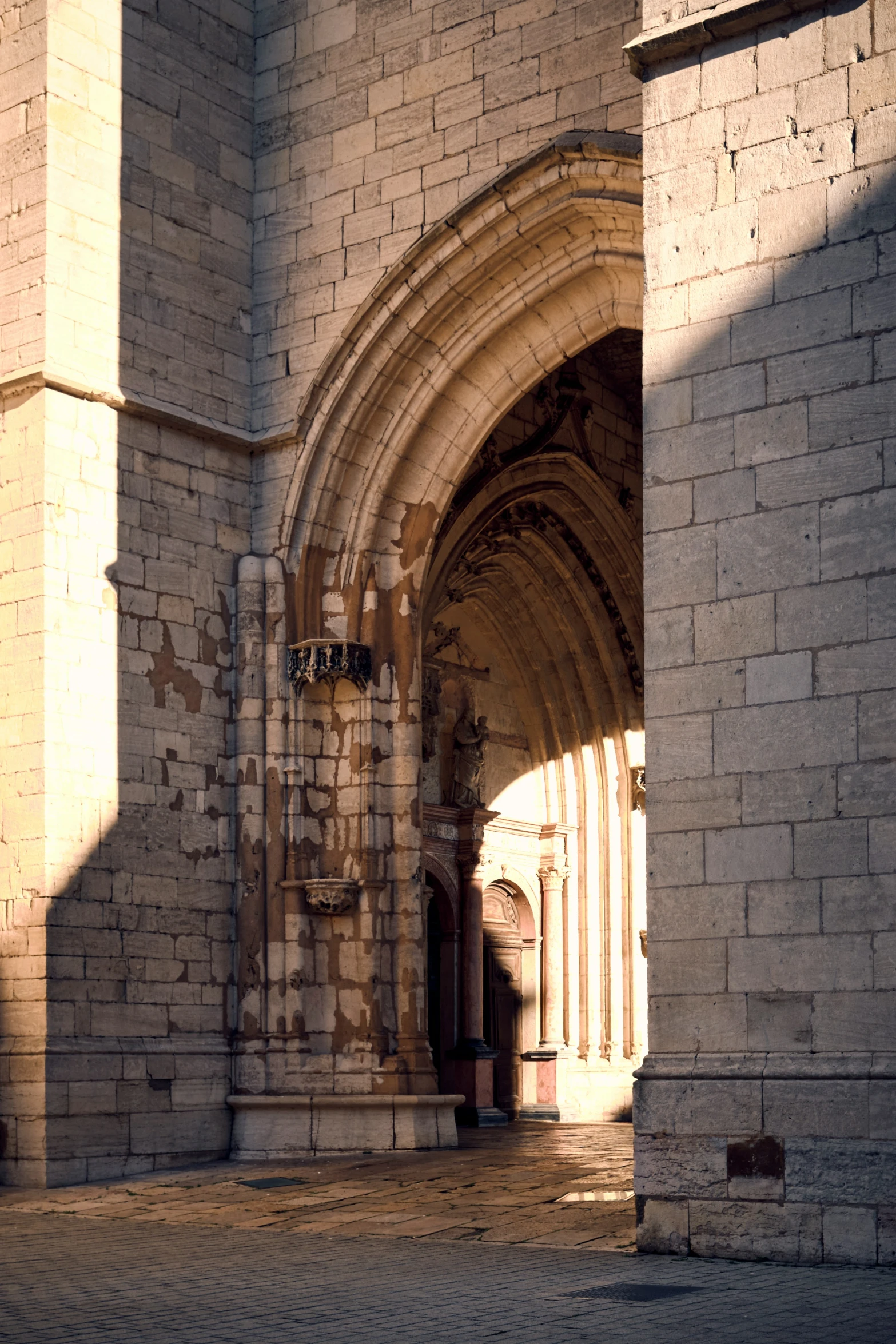 a light shines down on an ornate arch