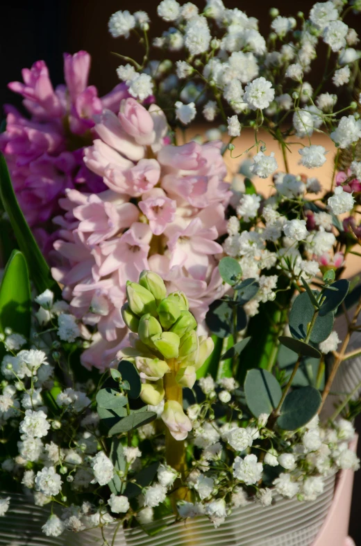 different types of flowers are in the vase