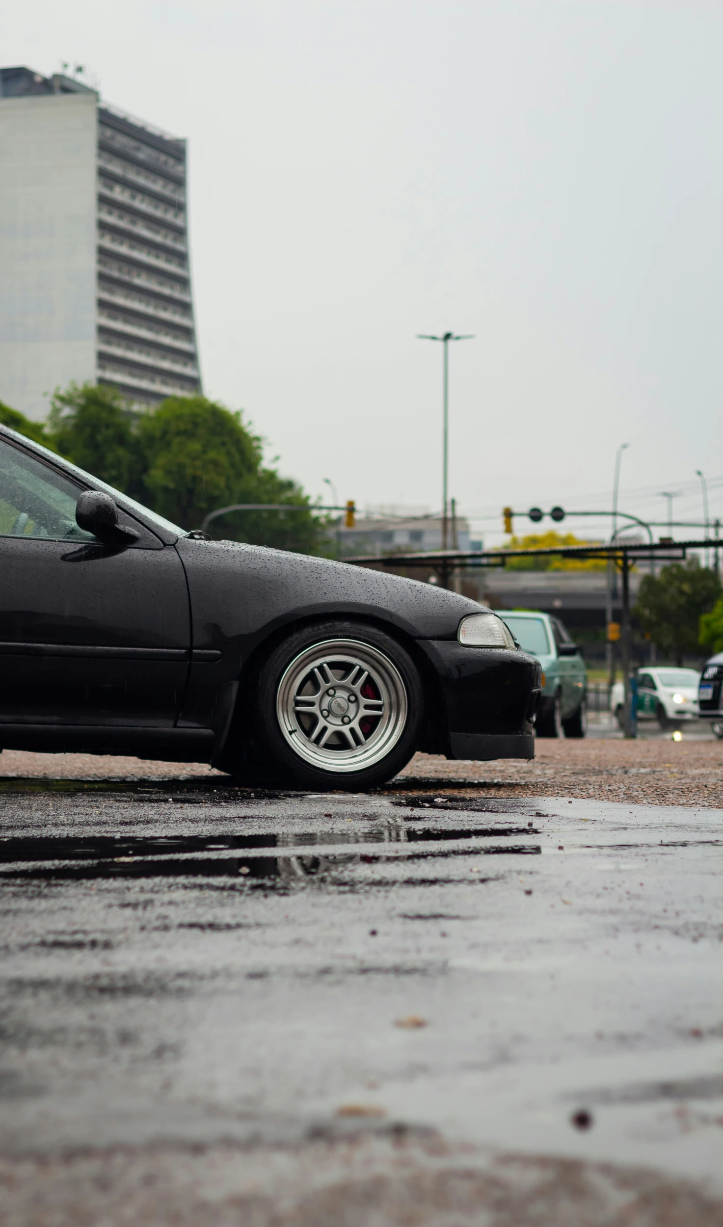 a car is parked on the street in the rain