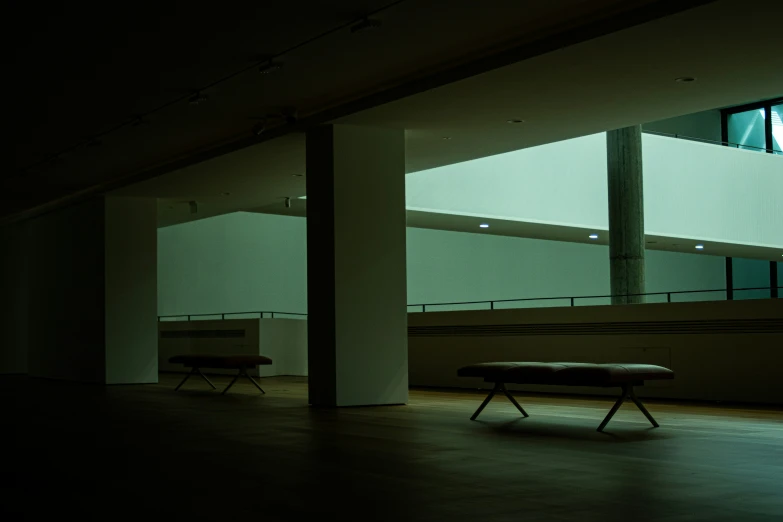 dark room with benches and a window