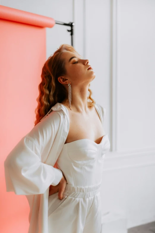 a woman looking up into the sky next to a lamp