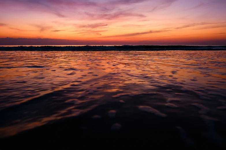 sunset, taken from a beach with the sun low on horizon