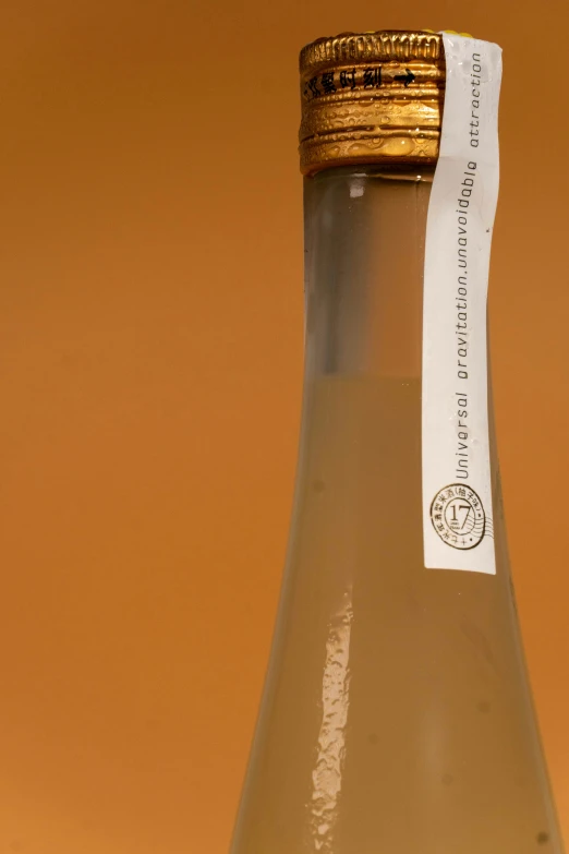 an empty bottle with a white paper sticker