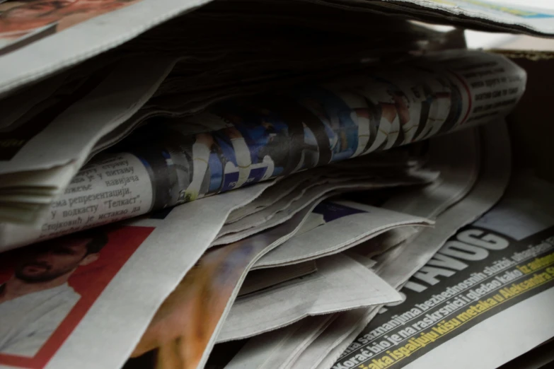 newspapers piled high in a pile on top of each other