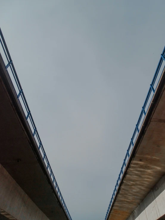 view looking up at a long, curving bridge