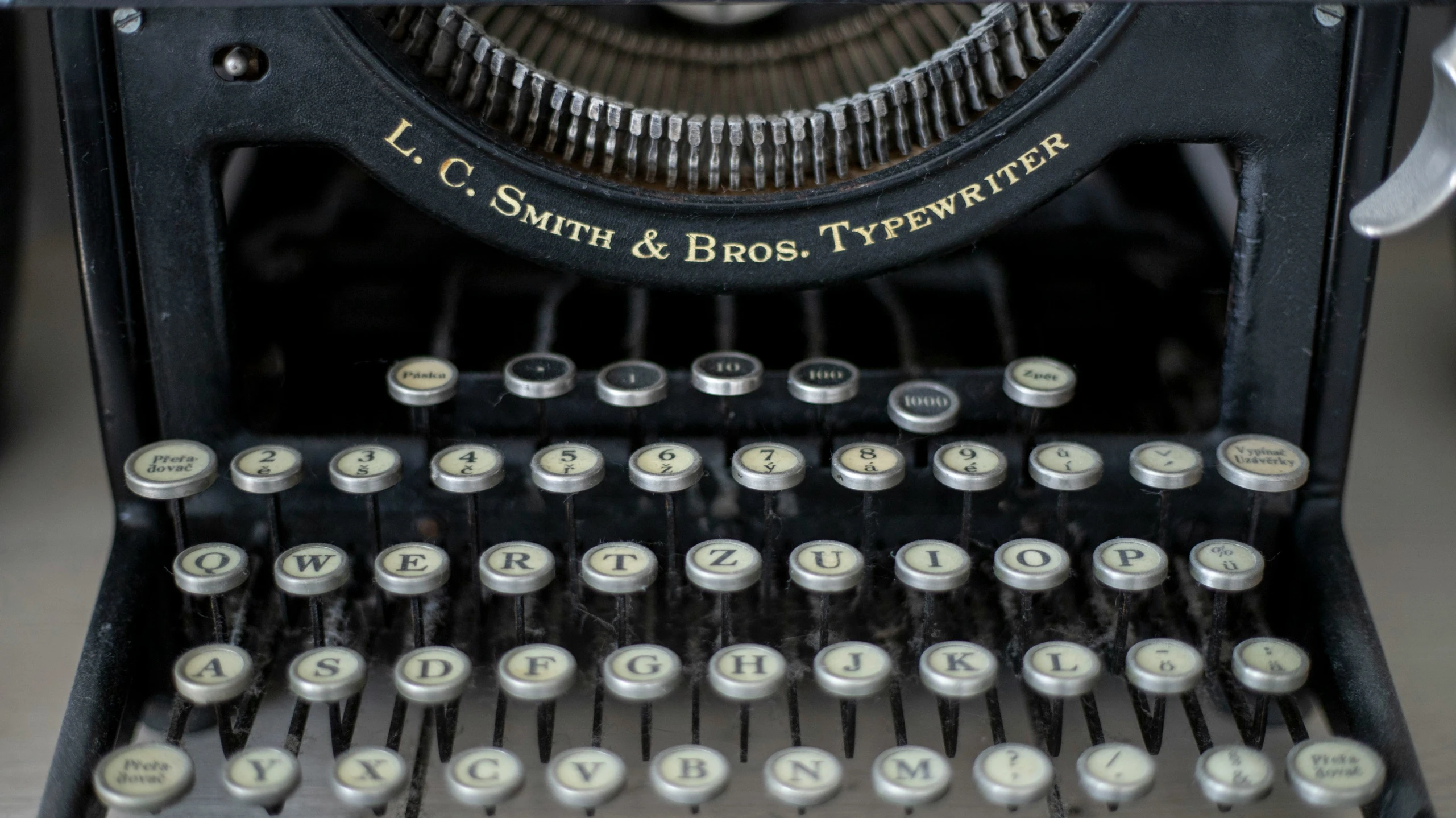 old black antique typewriter with letters and numbers