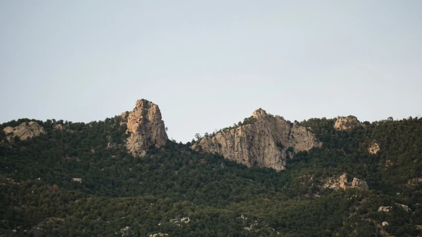 a mountain that has two hills and trees