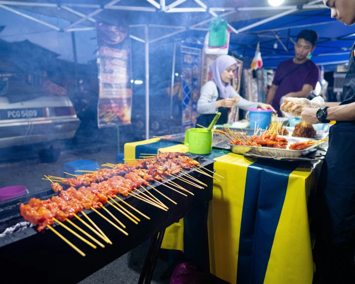 food and food stand are seen at an outdoor fair