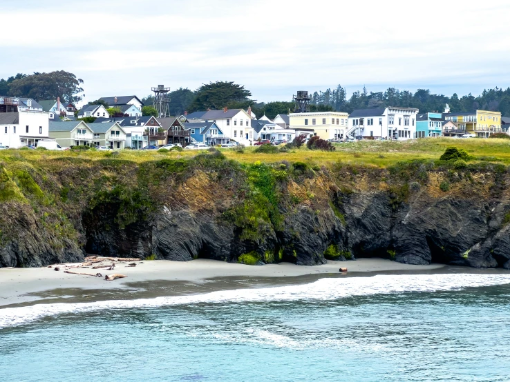 this po is from across the water, it looks like a cliff face with a beach and house's on the other side