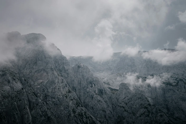 a black and white po shows the mountain range, with a dark sky above