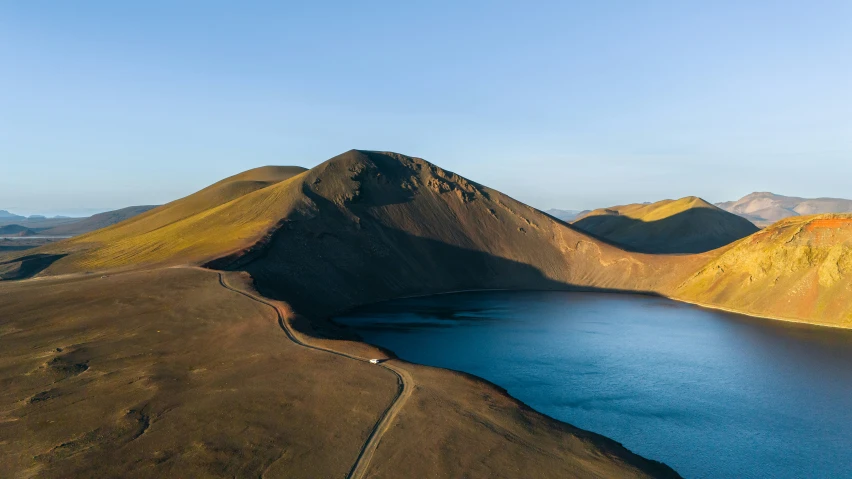 a large body of water with mountains in the background