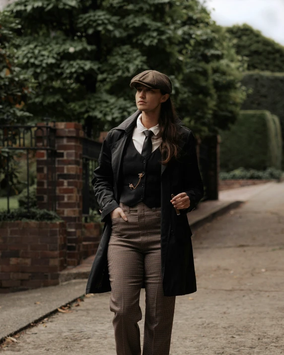 a woman dressed in a tie and coat walking